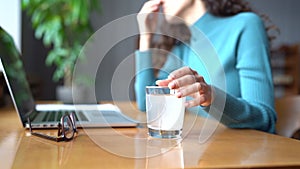 Unhealthy woman feel sick hold glass of water with dissolving effervescent aspirin pill for headache