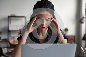 Unhealthy woman suffer from migraine working on computer