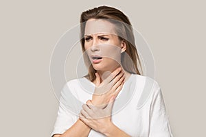 Unhealthy woman touch neck having sore throat or angina