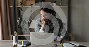 Unhealthy young businesswoman working on computer at home office.