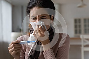 Unhealthy young latin woman suffering from flu grippe symptoms. photo