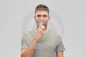 Unhealthy young man wearing oxygen mask