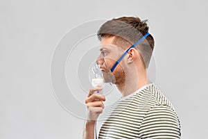 Unhealthy young man wearing oxygen mask