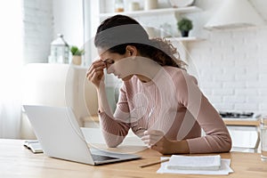 Unhealthy young woman massaging nose bridge, having dry eyes syndrome.