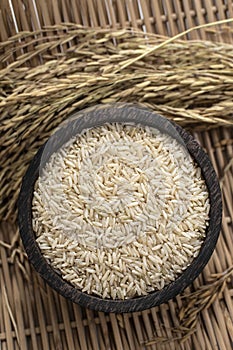 unhulled asian brown rice grains in rustic setting display in Cambodia photo