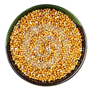 Unhulled proso millet grain in round bowl isolated photo