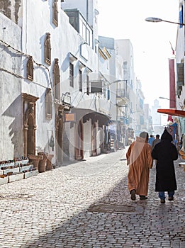 Unhurried city life in misty sunny morning on shopping street , medina of Essaouira, Morocco