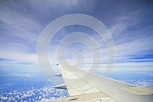 Unic cloud formation with blue sky, view from flight windows with copyspace area