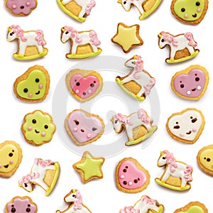 Unicorn and heart shaped sugar cookies decorated with pastel royal icing on white background