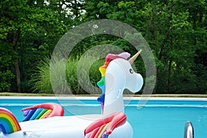 Unicorn inflatable floating in a backyard swimming pool