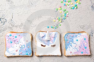 Unicorn toasts with colorful stars, food for kids idea, top view