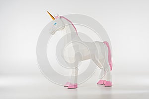 unicorn toy with golden horn with pink hooves