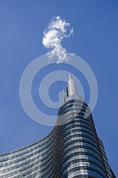 Unicredit tower, square Gae Aulenti, Milan, Italy. Spire and cloud photo