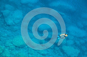 Unidentifiable couple swimming in the Mediterranean Sea in Greece near the island of Lefkas