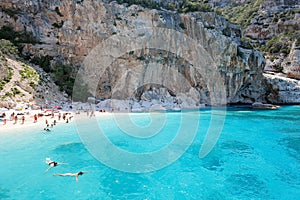 Unidentifiable People on one of the beautiful beach in Sardinia, Italy