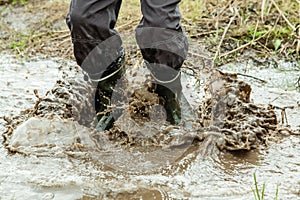 Unidentifiable person jumping in muddy water