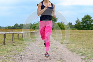 Unidentifiable runner with pink pants jogging