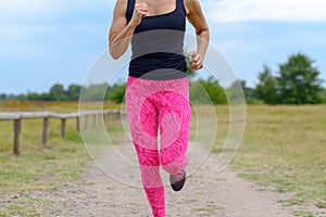 Unidentifiable runner with pink pants jogging