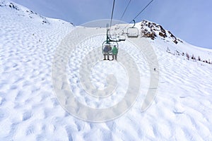 Skiers on Chairlift Up a Ski Slope in the Canadian Rockies