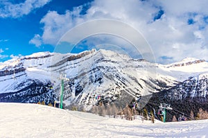 Skiers on Chairlift Up a Ski Slope in the Canadian Rockies