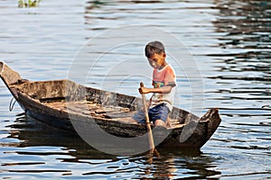 An unidentified boy on a boat floating on Tonle Sap lake