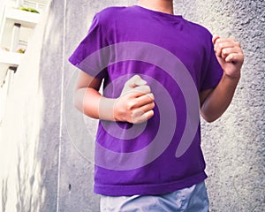 Unidentified boy running and jogging with concrete background