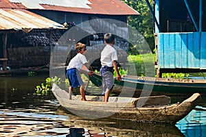 An unidentified boys on a boat floating on Tonle Sap lake