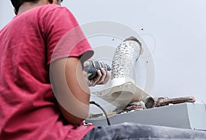 Unidentified builder making construction for ventilation