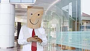 Unidentified businessman texting in office lobby