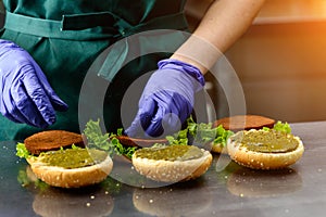 Unidentified chef preparing veggie burgers with yummy vegetable