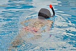 Unidentified child snorkeling in water