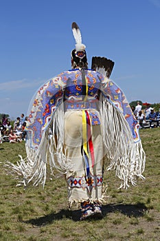 Unidentified female Native American dancer wears traditional Pow Wow dress during the NYC Pow Wow