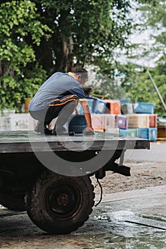 An unidentified fishmonger is cleaning his truck lorry at the end of the day