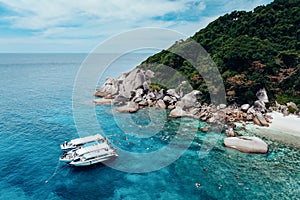 Unidentified group of tourists or traveller are swimming and snorkeling relaxation in Andaman sea, Thailand