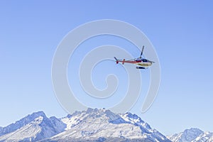 Unidentified helicopter flying over the amazing West Coast, South Island, New Zealand