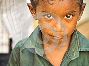 Unidentified indian dalit shy cute boy in the street. Children of Tamil Nadu suffer of poverty