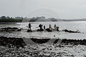 Unidentified local people work on the coast of the Orange islan