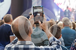 Unidentified man filming scene by pad during a concert dedicated Moscow city day on September 9, 2019