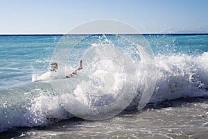 Unidentified man swimming in large waves