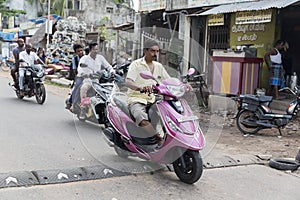 Unidentified motorbike scooter in typical traffic situation on indian street in India