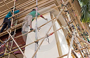 Unidentified painter on scaffolding doing renovate for architec