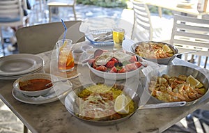 Unidentified people eating traditional delicious mediterranean dish  outdoor restaurant  in Cyprus