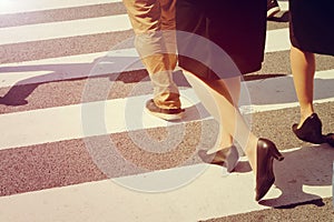 Unidentified people legs crossing street