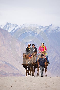 Unidentified people travellers riding on camels