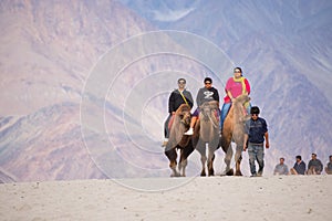 Unidentified people travellers riding on camels