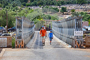 Unidentified people visit famous truss bridge over Aradena Gorge on Crete Island, Greece