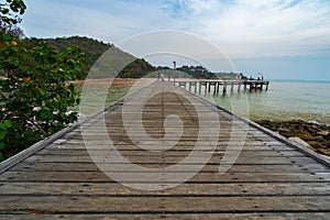 Unidentified people at wooden plank pier bridge at Khao Laem Ya in Mu Ko Samet National Park, Rayong Province, Thailand