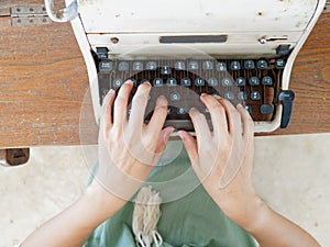 Unidentified personâ€™s hand typing on retro typing machine