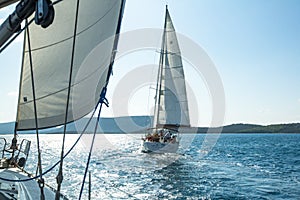 Unidentified sailboats participate in sailing regatta on Aegean Sea.