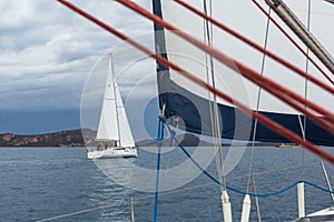 Unidentified sailboats participate in sailing regatta 12th Ellada Autumn-2014 on Aegean Sea.